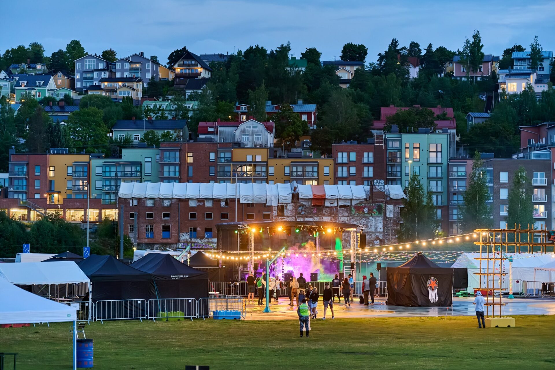 Santalahden rantapuiston tapahtumakävijöitä iltahämärässä.